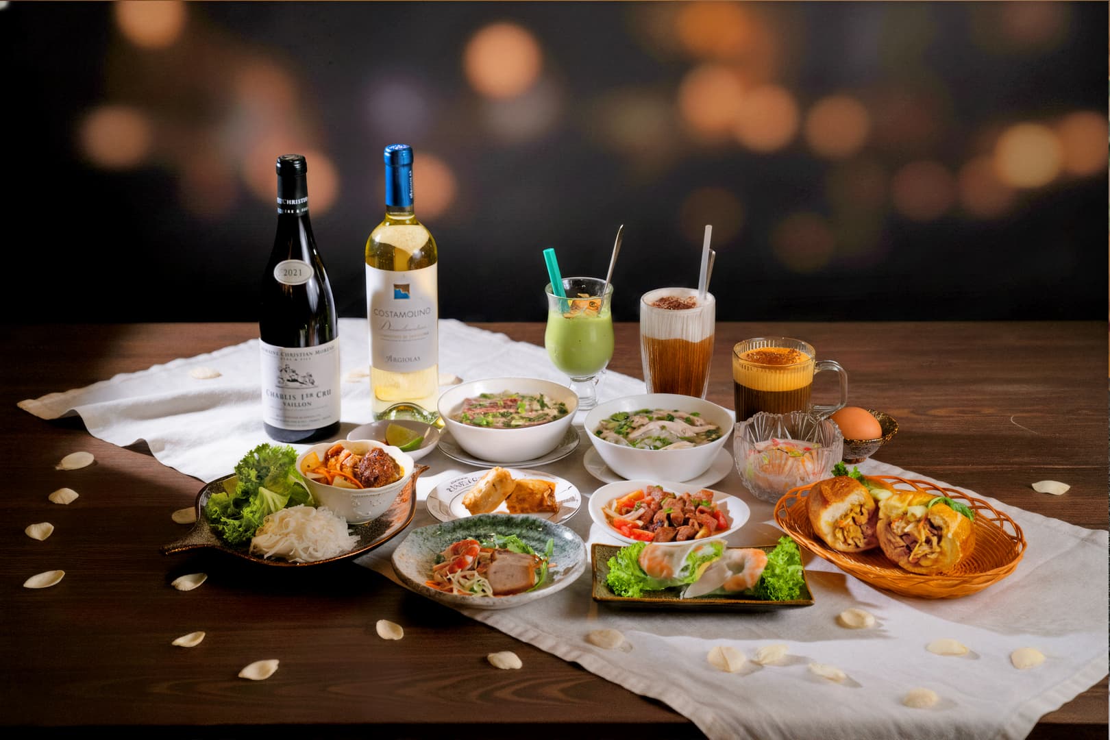 A YENNEY table set with pho, spring rolls, banh mi and Vietnamese drinks